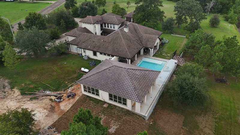 Aerial view of custom pool house and deck